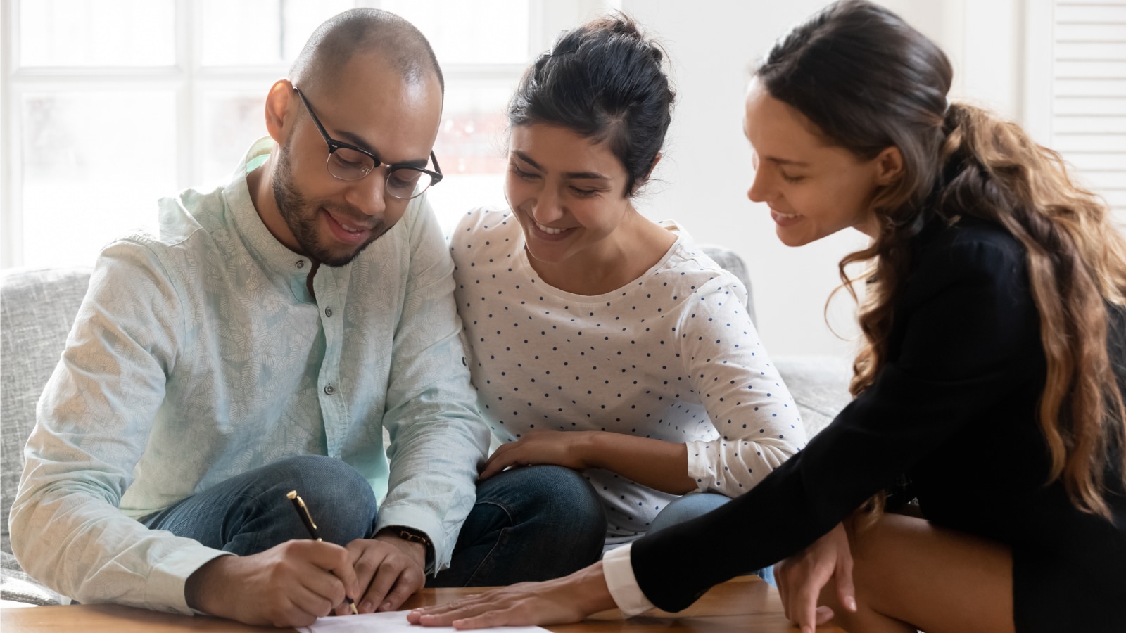 female insurance agent discussing life insurance options with young couple